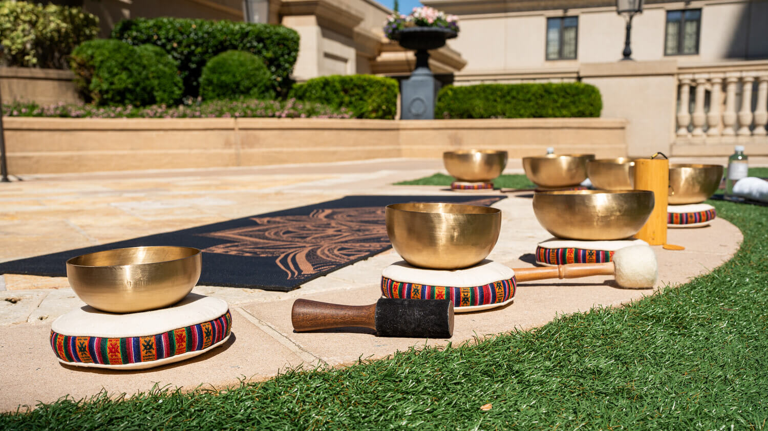Cool Things to Do in November in Atlanta 9 Golden singing bowls arranged on cushions for meditation or sound healing outdoors in Atlanta, Georgia.