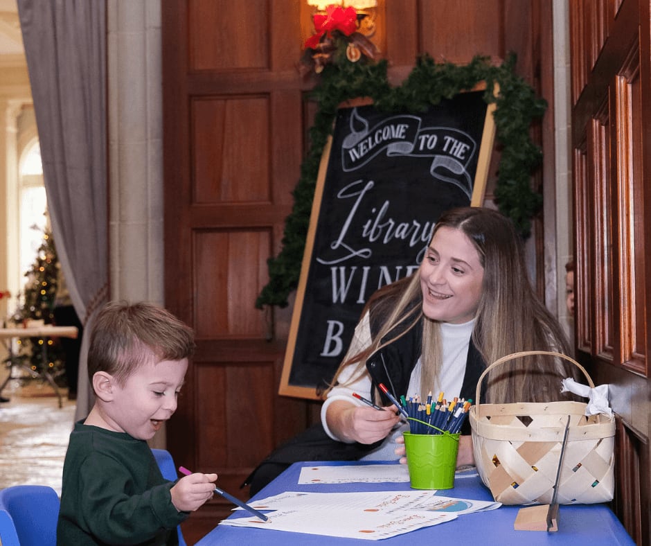 A woman and child are seated at a table, engaged in coloring activities in Atlanta, Georgia.