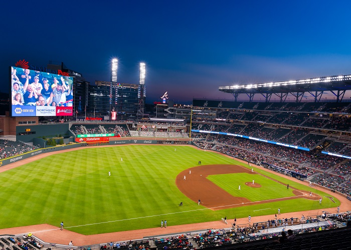 A wide view of the Atlanta Braves playing at Truist Park filled with fans.