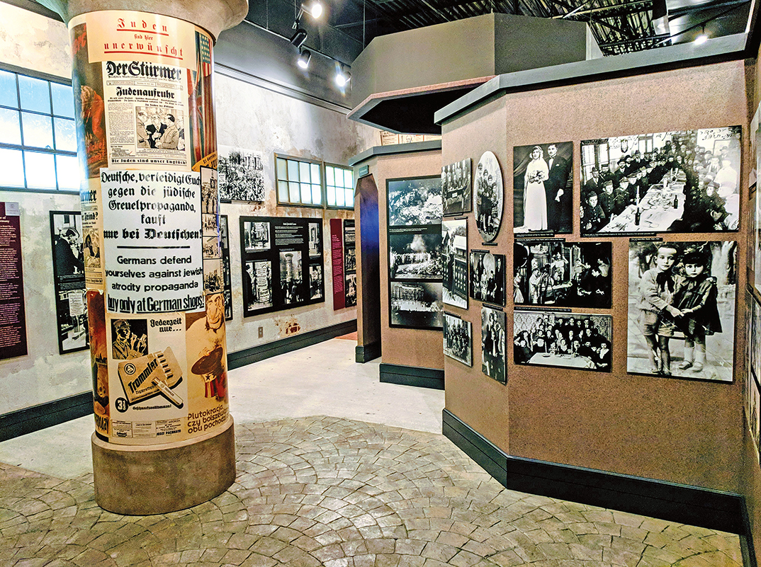 Museum walls with pictures and posters on them.