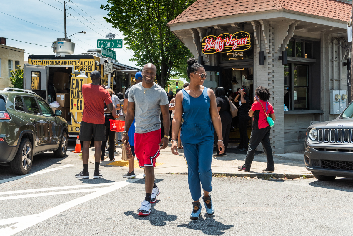 Couple walking in front of Slutty Vegan Restaurant