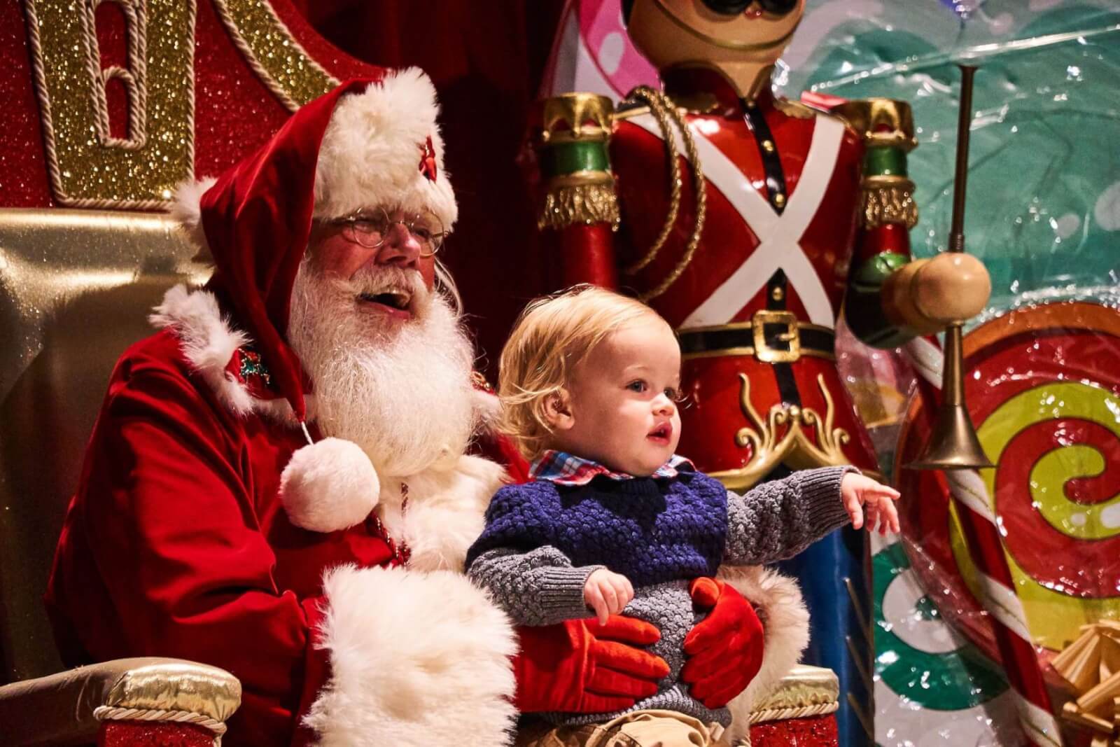 A child sitting on Santa's lap for a photo at Zoo Atlanta.