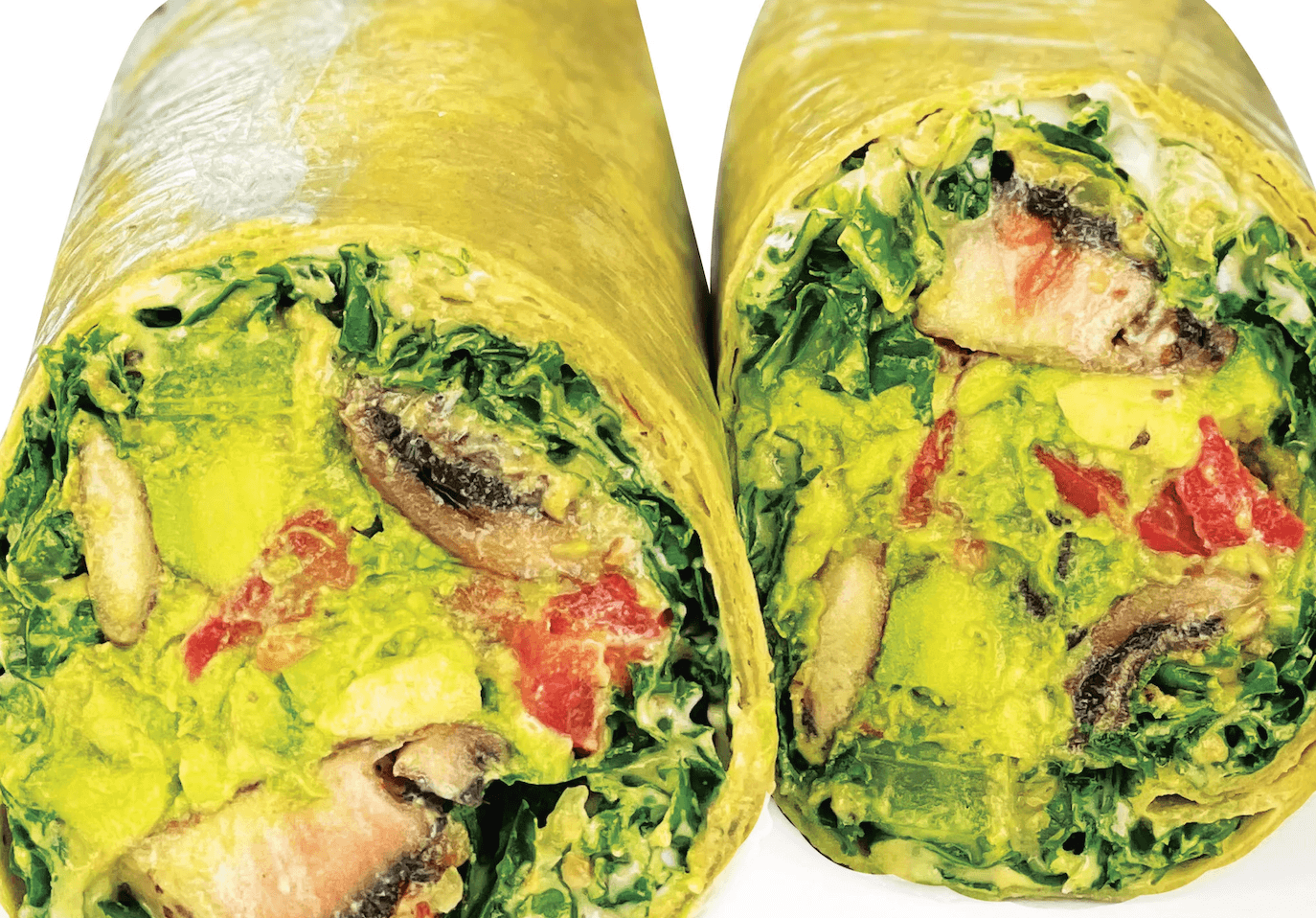 Two vibrant green veggie wraps filled with fresh avocado, tomatoes, and leafy greens in Atlanta, Georgia.