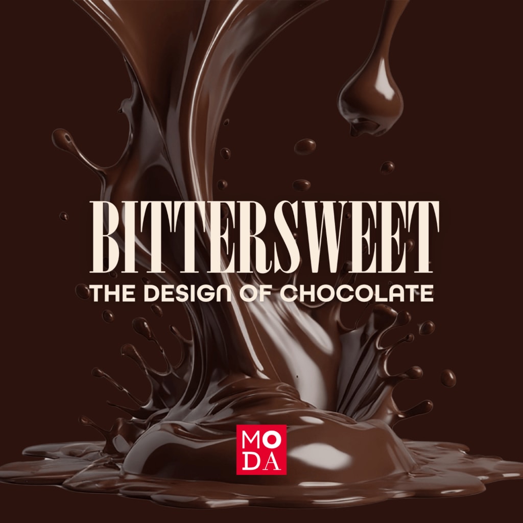 A dark brown chocolate fountain splashes dramatically against a black background in Atlanta, Georgia.