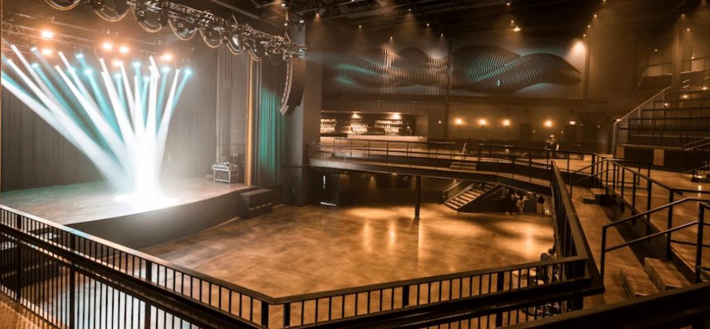 A modern concert venue with a large stage, dramatic lighting, and a spacious audience area in Atlanta, Georgia.