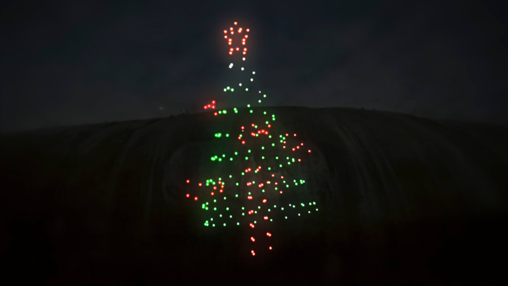 A Christmas tree made of lights projected onto a waterfall at night in Atlanta, Georgia.