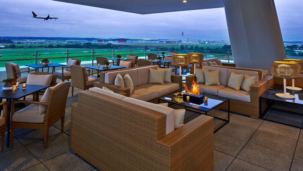 A view of a plane landing at The Rooftop Bar at Overland | Kimpton Overland Hotel.