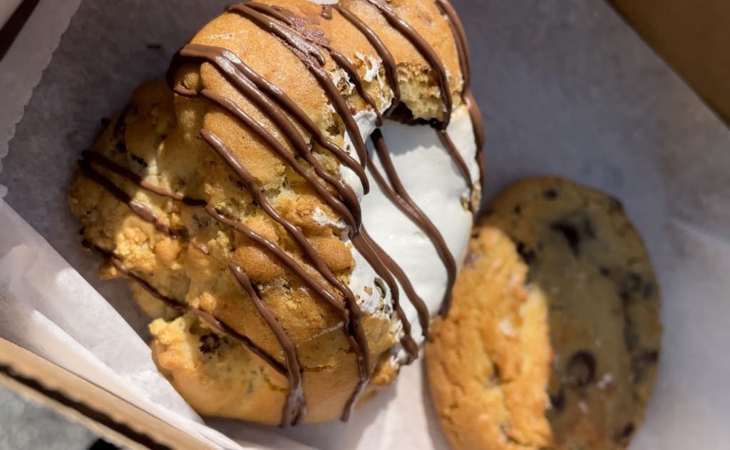 Two cookies, one with marshmallow and chocolate drizzle, the other with chocolate chips in Atlanta, Georgia.