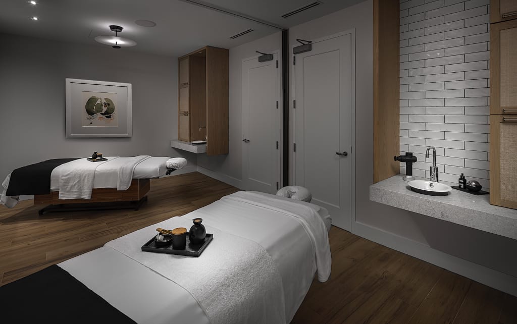 Relax and Rejuvenate: Your Ultimate Atlanta Wellness Itinerary 3 A serene spa room with two massage tables, a sink, and minimalist decor in Atlanta, Georgia.