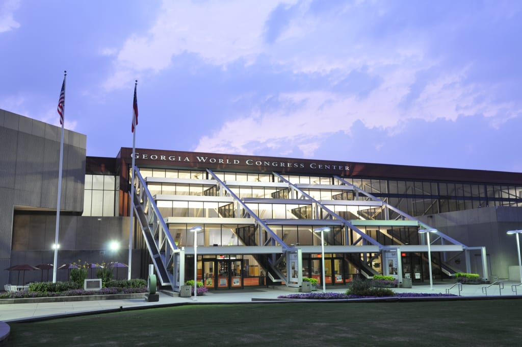 A modern, multi-story building with a glass facade and a large sign reading 'Georgia World Congress Center' in Atlanta, Georgia.
