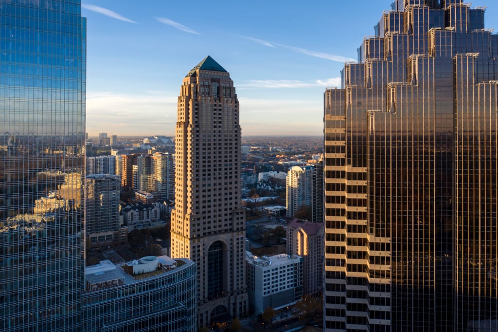 Sunlit skyscrapers with reflective glass facades dominate the city skyline in Atlanta, Georgia.