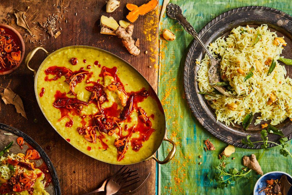 A vibrant spread of Indian cuisine featuring a yellow lentil curry and rice dishes in Atlanta, Georgia.