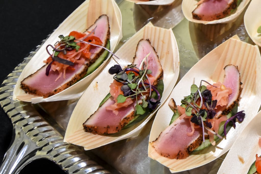 bamboo dishes with slice of tune and garnished