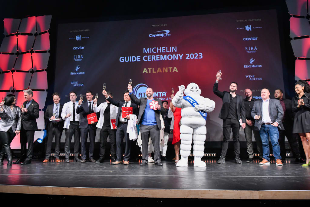 image of Mara Davis, Andrew Wilson, Marc Dezenski, J. Trent Harris, Ron Hsu, Aaron Phillips, Elisabeth Boucher-Anselin celebrate during Atlanta's MICHELIN Guide Ceremony 2023