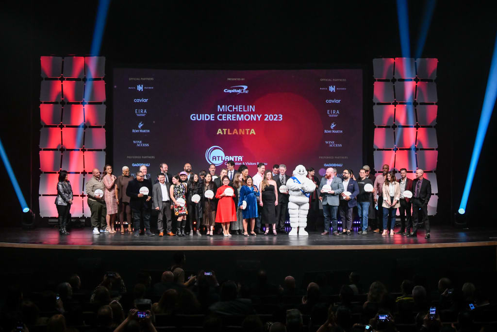 A diverse group of people stands on stage at the Michelin Guide Ceremony 2023 in Atlanta in Atlanta, Georgia.