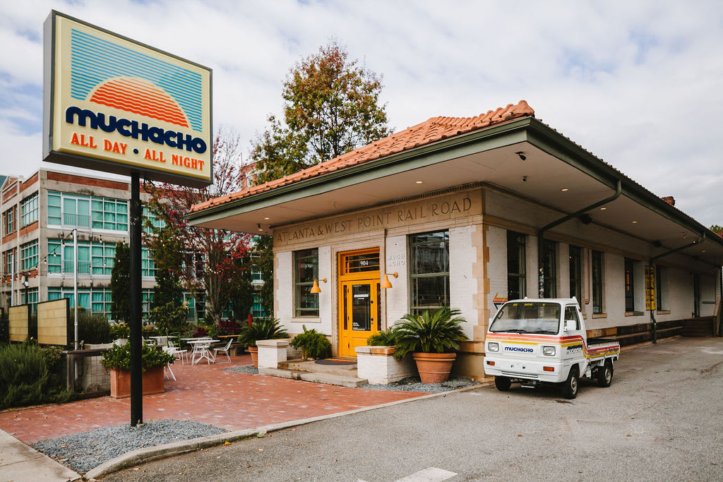 Explore Atlanta Beltline Southeast Trail 3 A colorful restaurant sign and building with a small truck parked outside in Atlanta, Georgia.