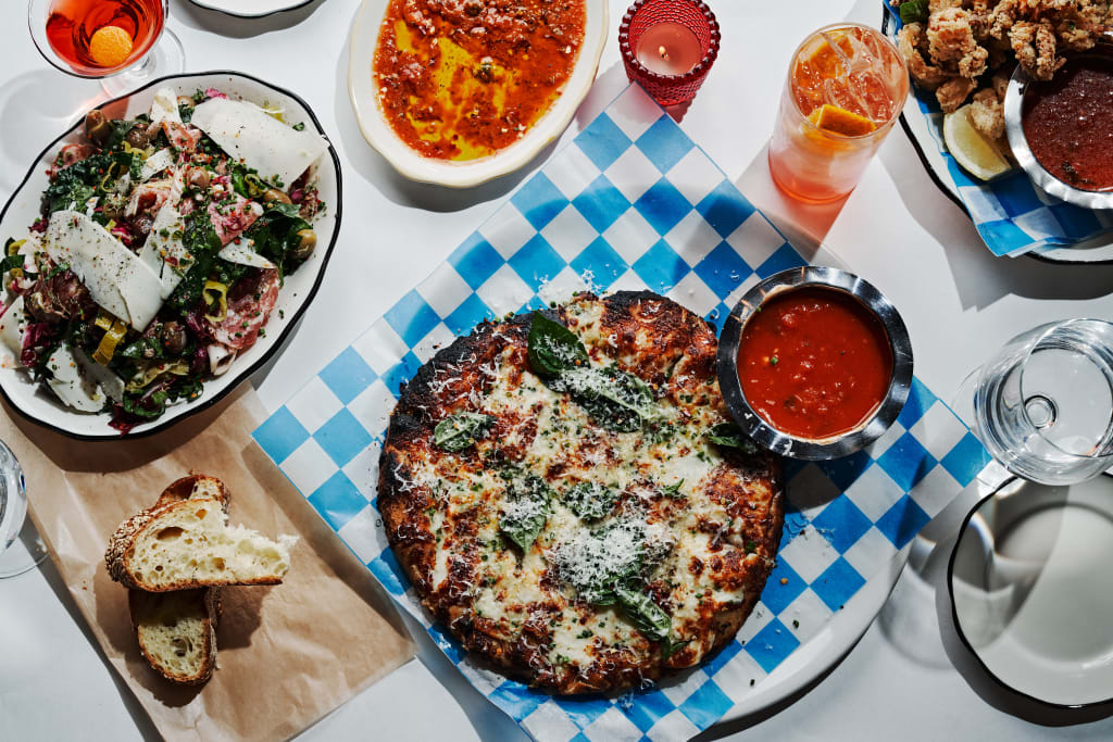 A table set with a variety of Italian dishes, including pizza, pasta, salad, and bread in Atlanta, Georgia.