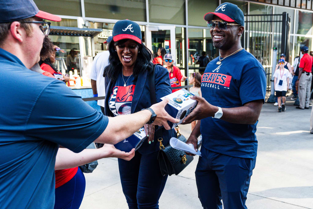 Atlanta Braves fans exchange merchandise and tickets outside a stadium in Atlanta, Georgia.