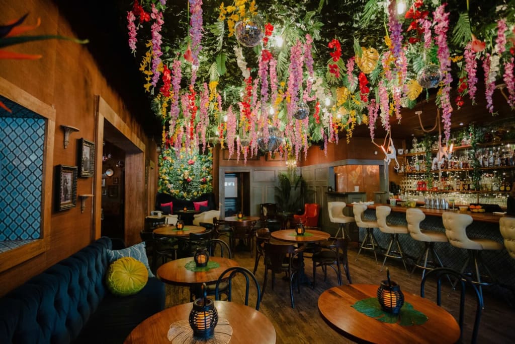 A vibrant, tropical-themed restaurant with colorful floral decorations and a cozy atmosphere in Atlanta, Georgia.