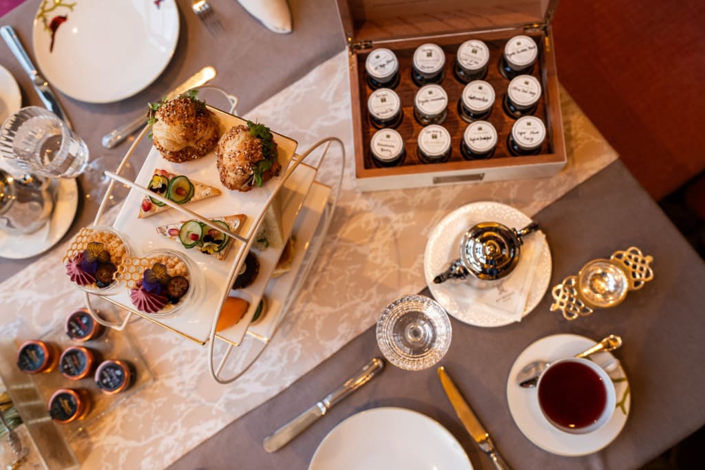 Grown-Up Guide to Halloween in Atlanta 3 Elegant afternoon tea spread with finger sandwiches, scones, pastries, and tea on a table in Atlanta, Georgia.