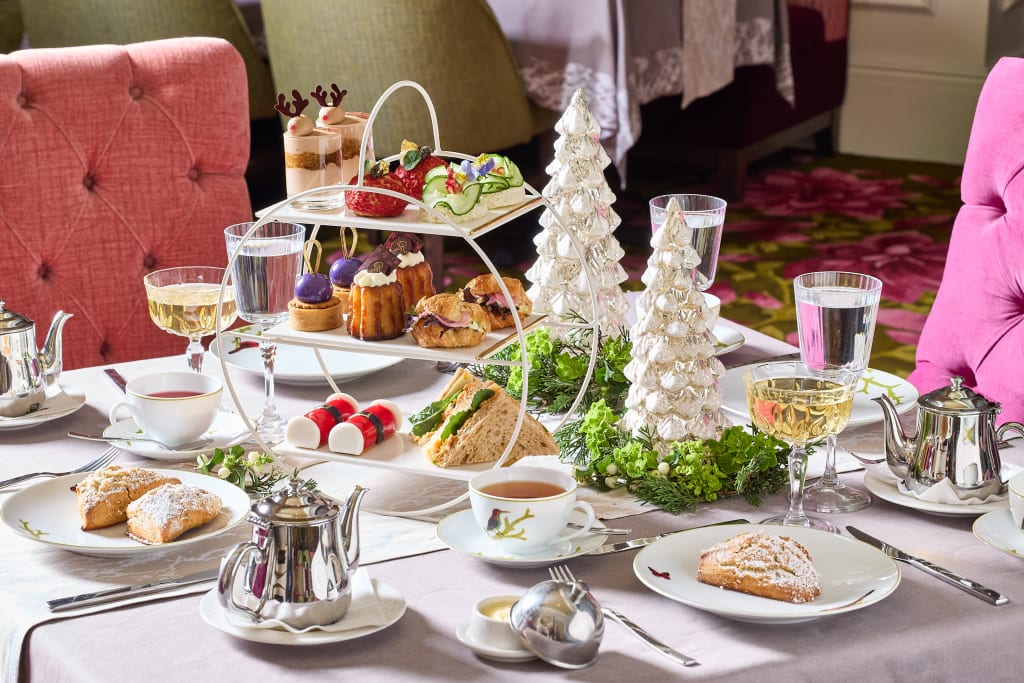 Elegant afternoon tea spread with festive decorations and various pastries in Atlanta, Georgia.
