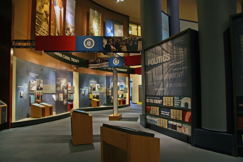 Interactive museum exhibit with podiums, displays, and large screens about politics and history in Atlanta, Georgia.