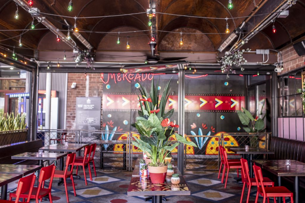 A vibrant and colorful patio greets guests at the eclectic Bar Mercado. 