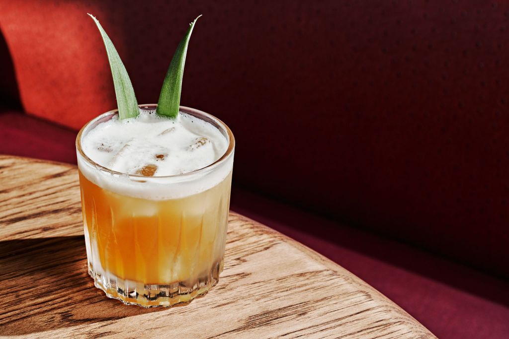 Must-Try Summer Cocktails in Atlanta 9 Orange drink on wood table