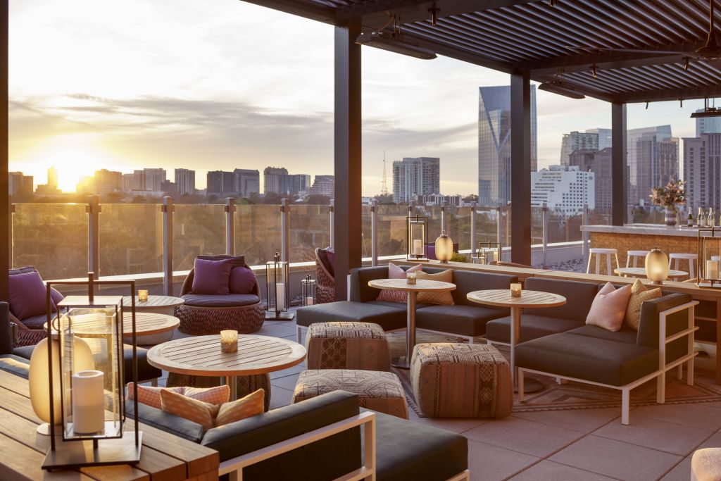 Couches and lounge chairs in front of an Atlanta skyline. 