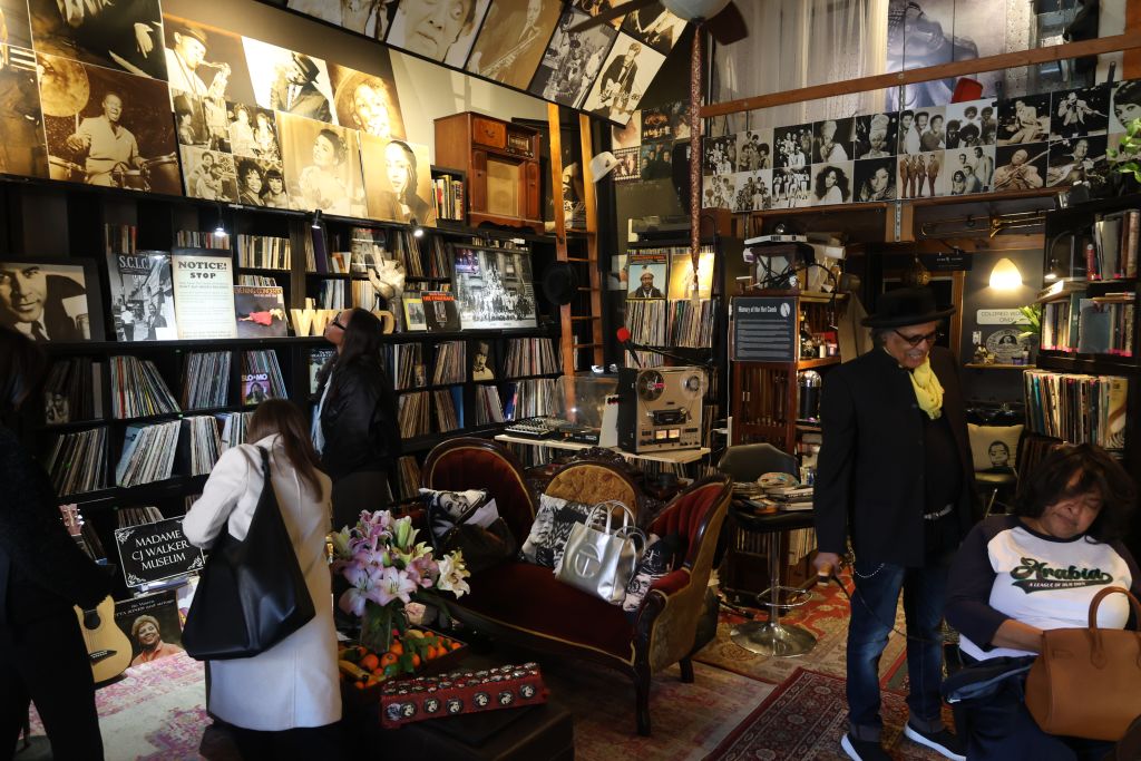 A cluttered vintage record store with customers browsing through records and memorabilia in Atlanta, Georgia.