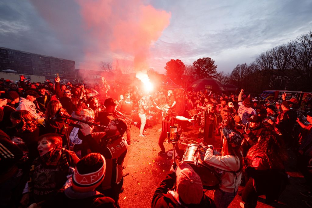 Crowd of people at night with red smoke and bright light in the center in Atlanta, Georgia.