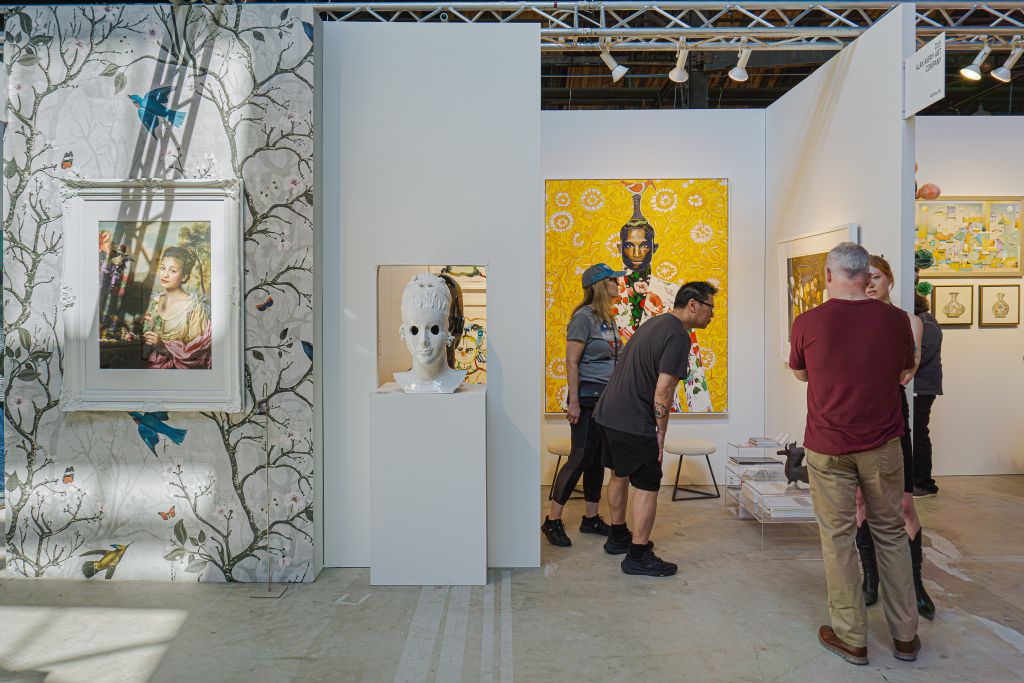 Ultimate Guide to Atlanta Art Fair 2026 2 Visitors admire diverse artworks in a modern art gallery with vibrant murals and sculptures in Atlanta, Georgia.