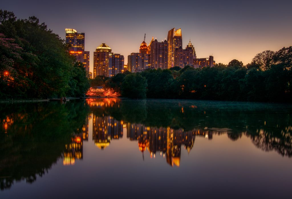 Atlanta skyline over Lake Clara Meer at Piedmont Park at night. 