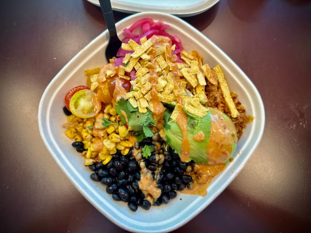 A colorful Mexican-inspired bowl with rice, beans, corn, avocado, and tortilla chips in Atlanta, Georgia.