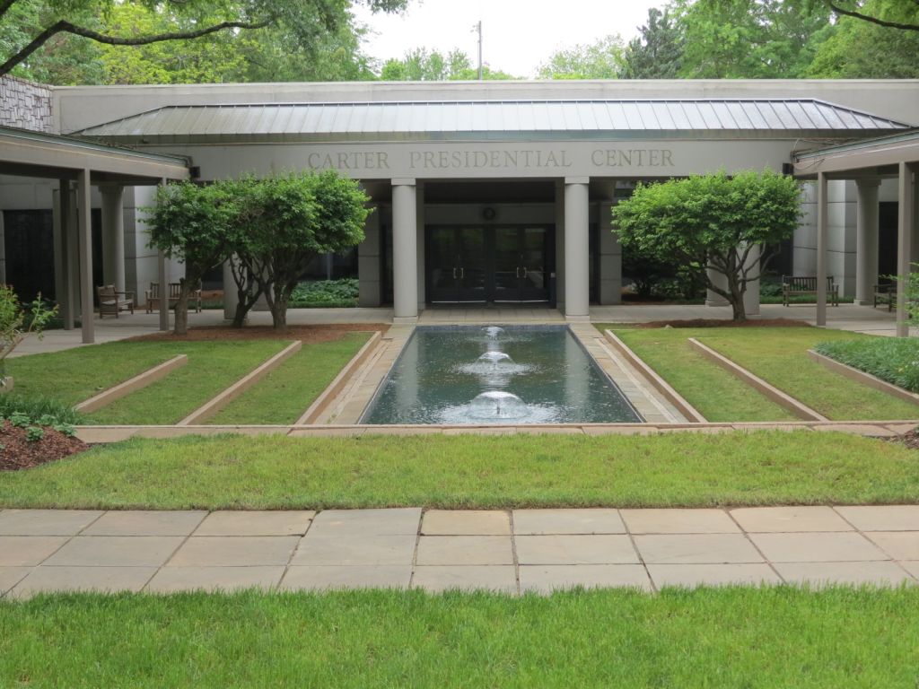 A modern building with a reflective pool and symmetrical landscaping in Atlanta, Georgia.