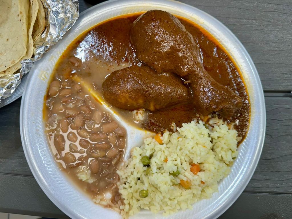 Ultimate Guide to Authentic Mexican Food in Atlanta 3 A plate of Mexican food with chicken in mole sauce, rice, beans, and tortillas in Atlanta, Georgia.