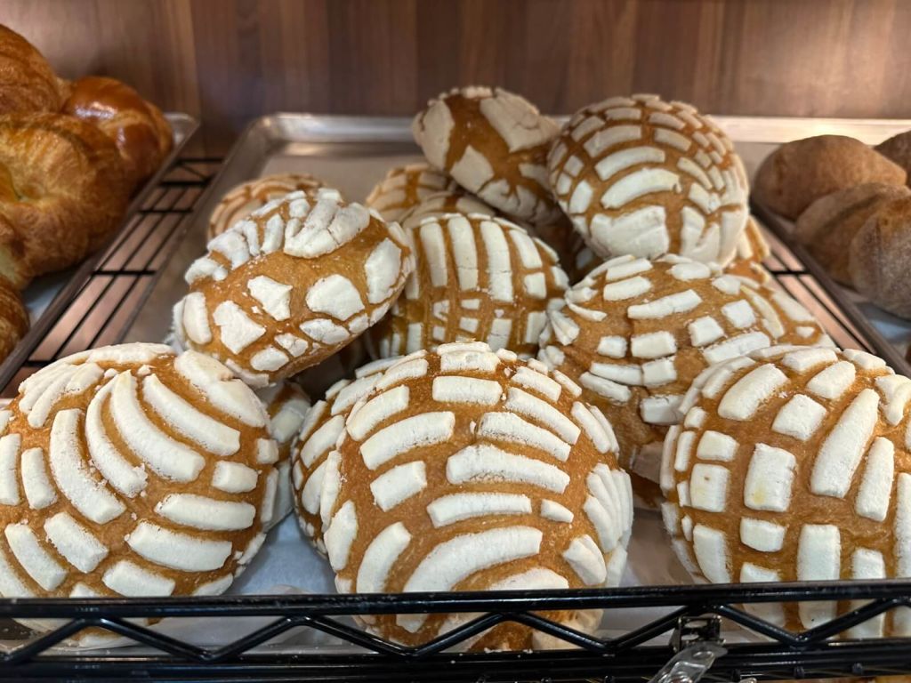 Ultimate Guide to Authentic Mexican Food in Atlanta 5 A tray of Mexican concha pastries with white sugar stripes on golden-brown shells in Atlanta, Georgia.