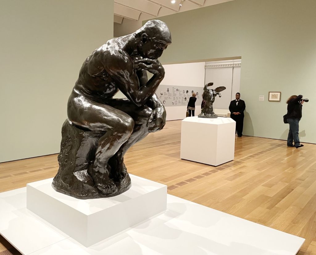 Statue of men thinking in a museum display.