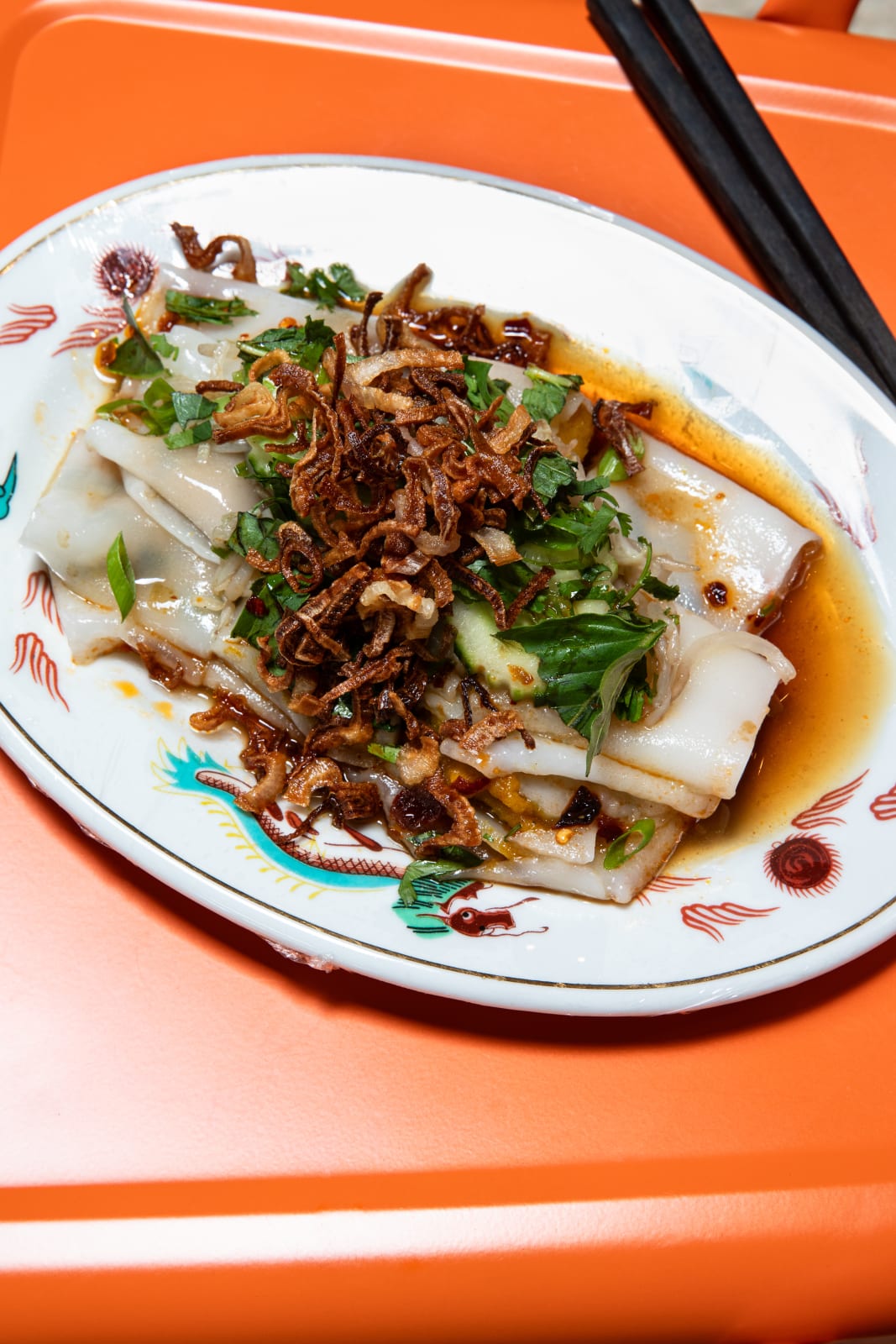 A plate of rice paper rolls topped with crispy fried shallots and fresh herbs in Atlanta, Georgia.