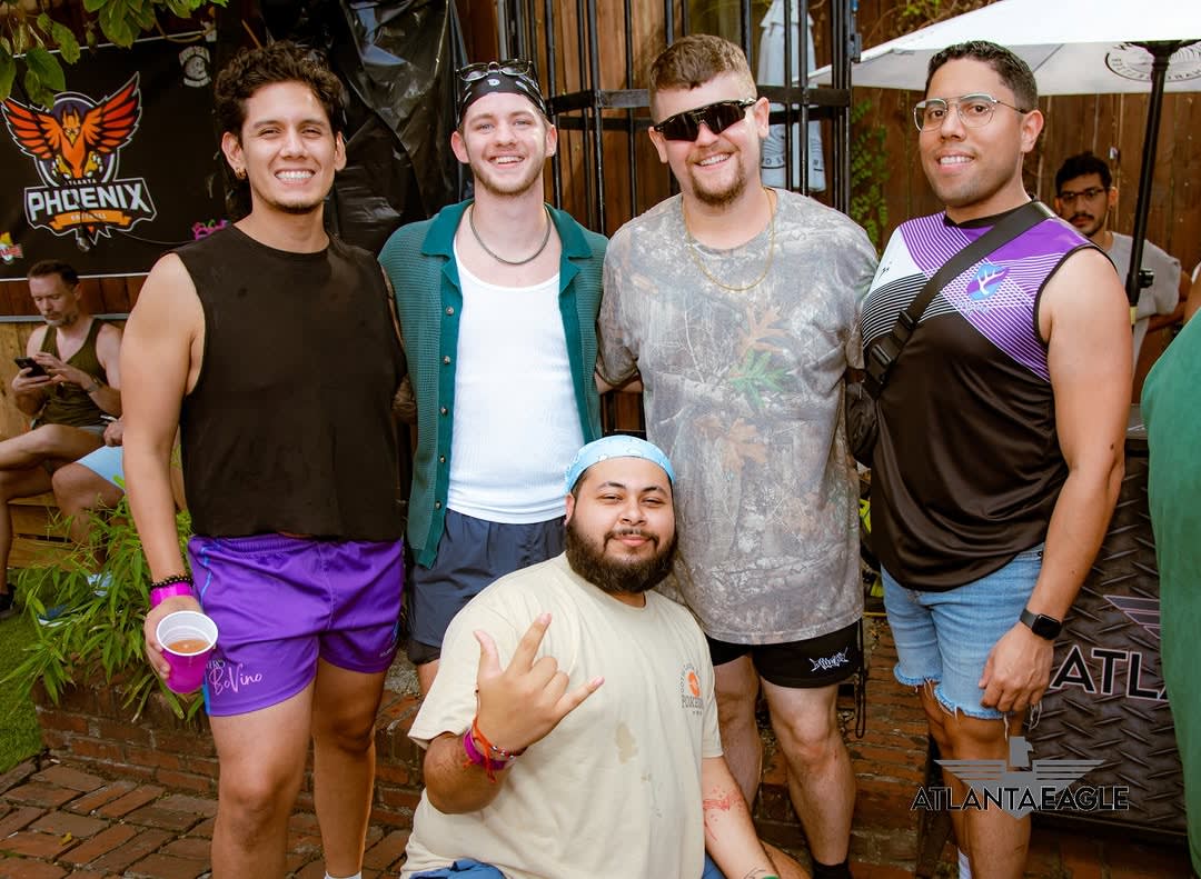 LGBTQ Bars and Nightlife in Atlanta 7 Five smiling men in casual summer attire pose together outdoors in Atlanta, Georgia.