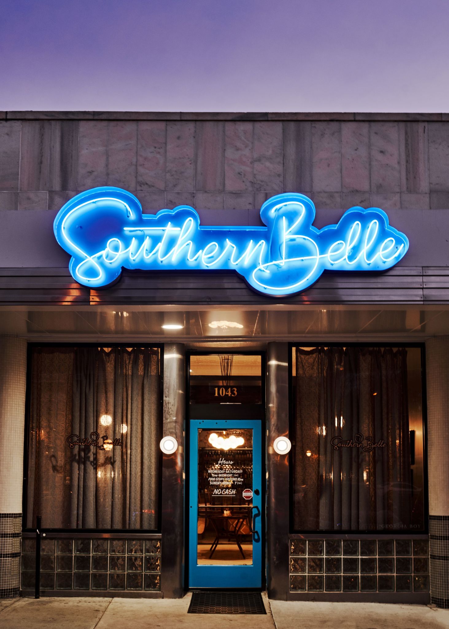 A restaurant entrance with a blue neon sign reading 'Southern Belle' above the door in Atlanta, Georgia.