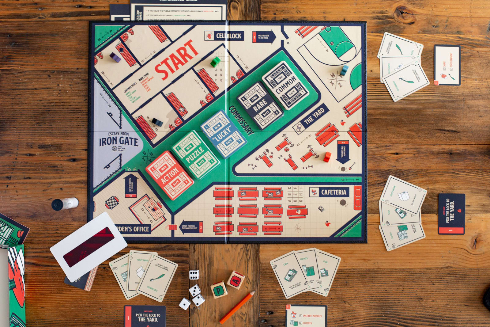 An escape room themed board game sits ready to play on a table. The board is offered online from The Escape Game Atlanta.