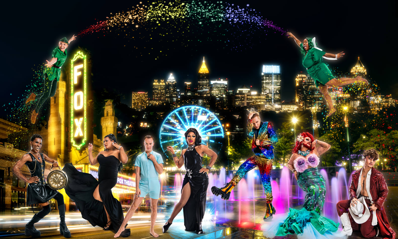 A vibrant nighttime scene featuring diverse performers in elaborate costumes dancing in front of a city skyline in Atlanta, Georgia.