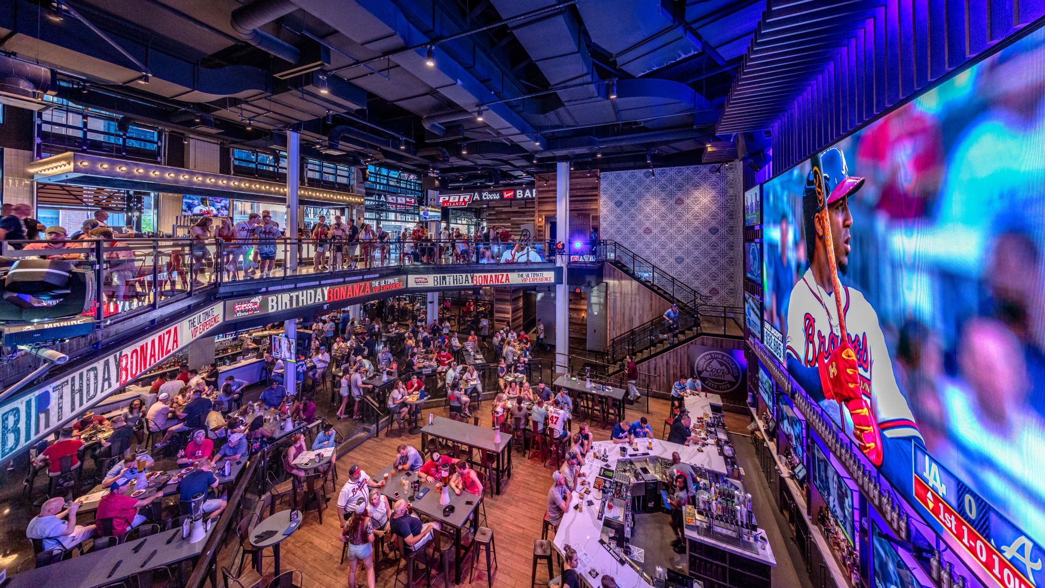 Fans enjoying food and live sports at Live! at The Battery in Atlanta.
