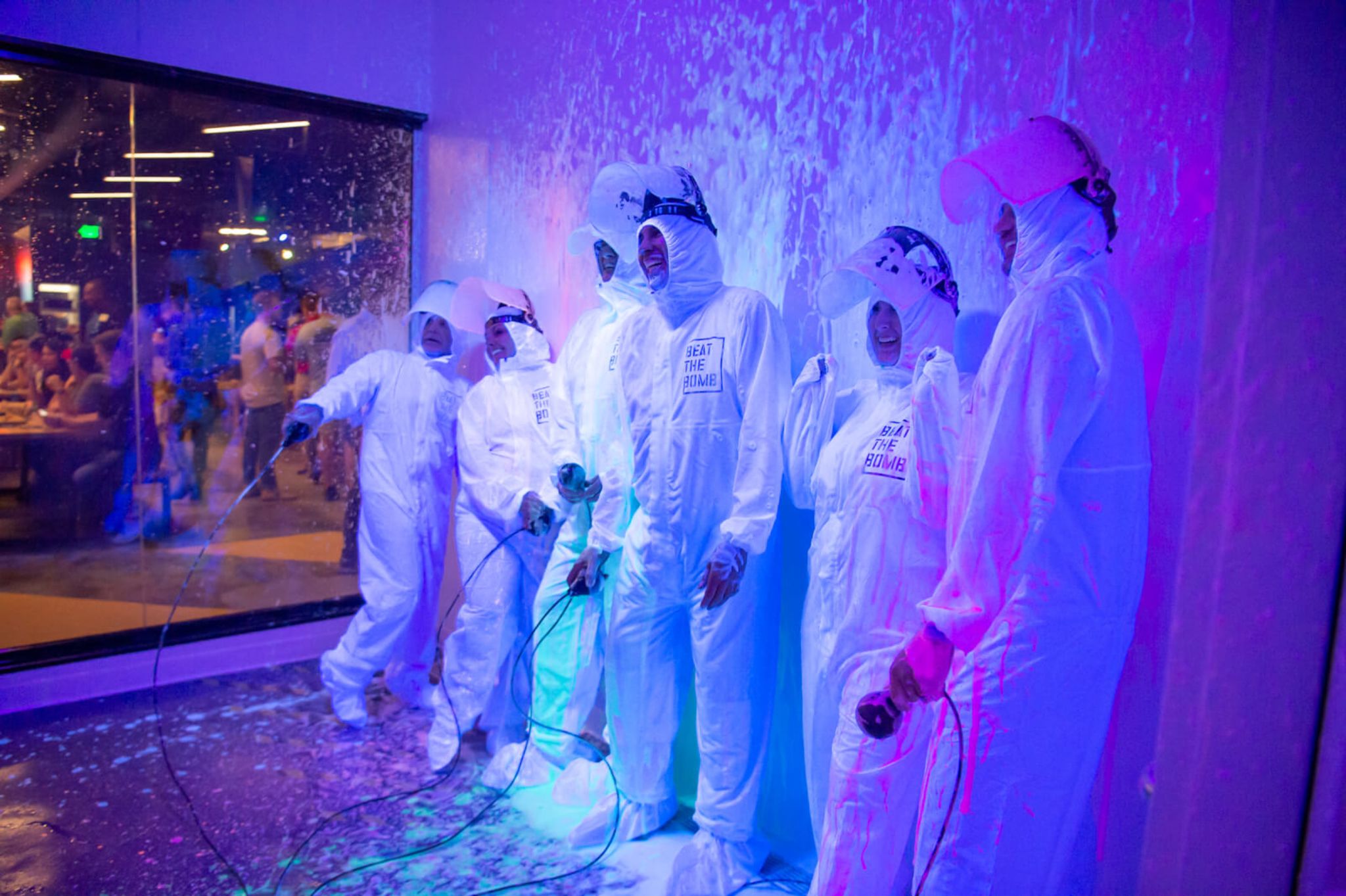 A group of friends in hazmat suits enjoying their time at Beat the Bomb in Atlanta.