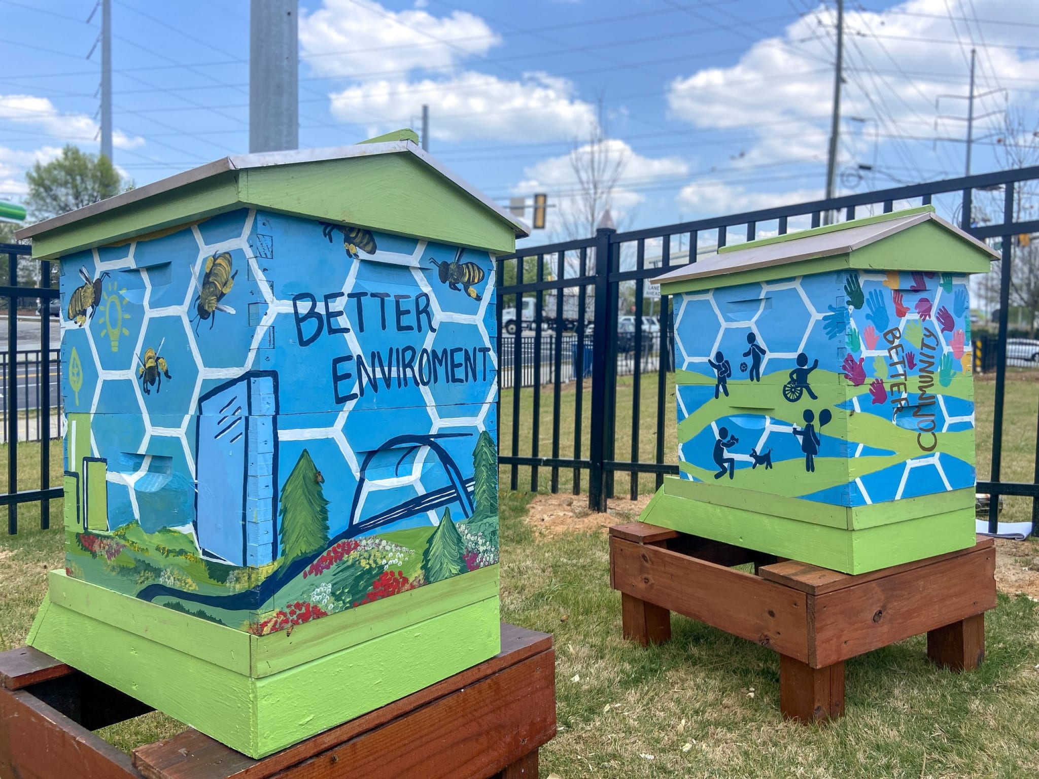 Two colorful beehives with murals promoting environmental awareness and community engagement in Atlanta, Georgia.