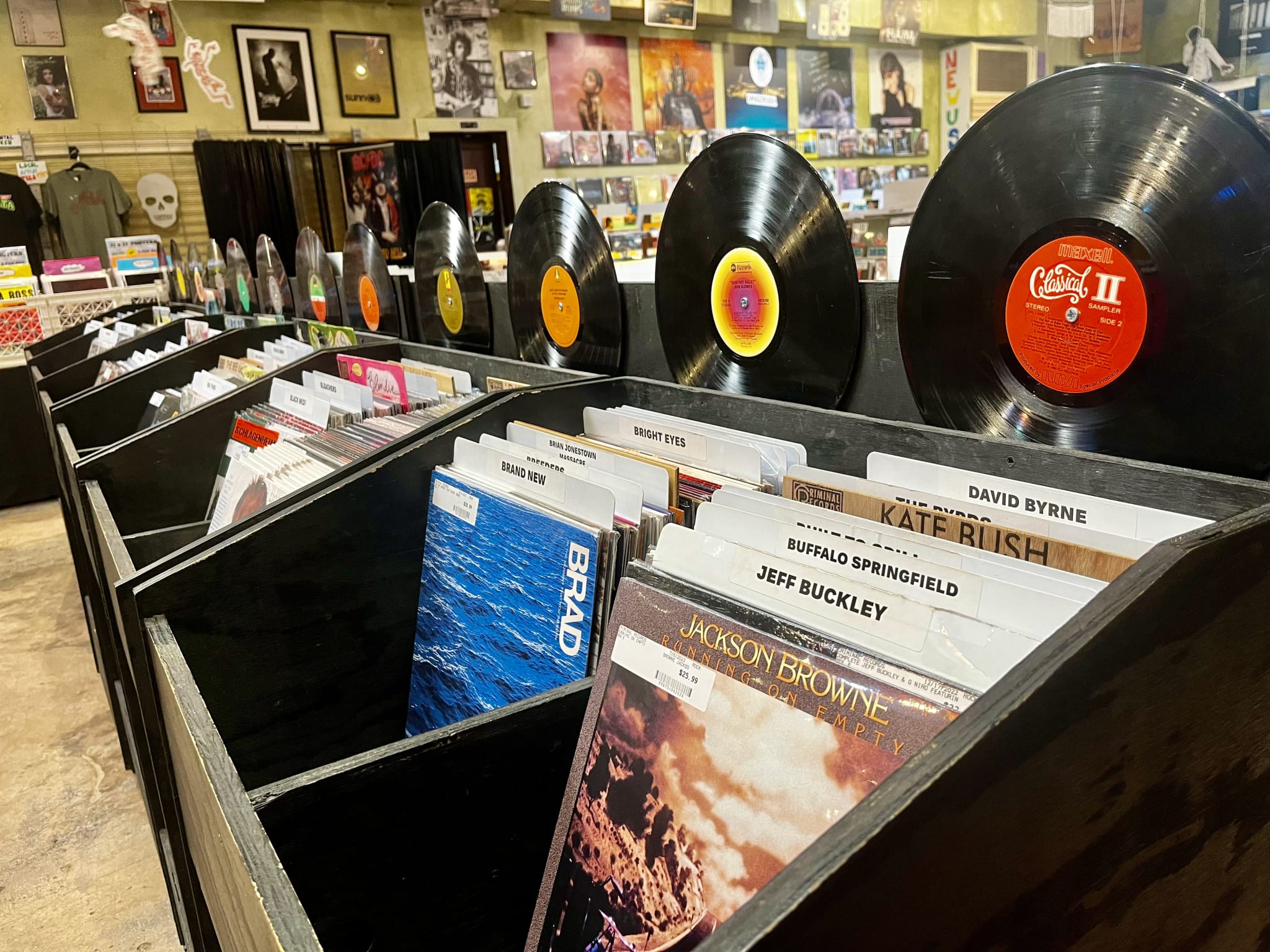 A record store with rows of vinyl records and CDs displayed in wooden crates in Atlanta, Georgia.