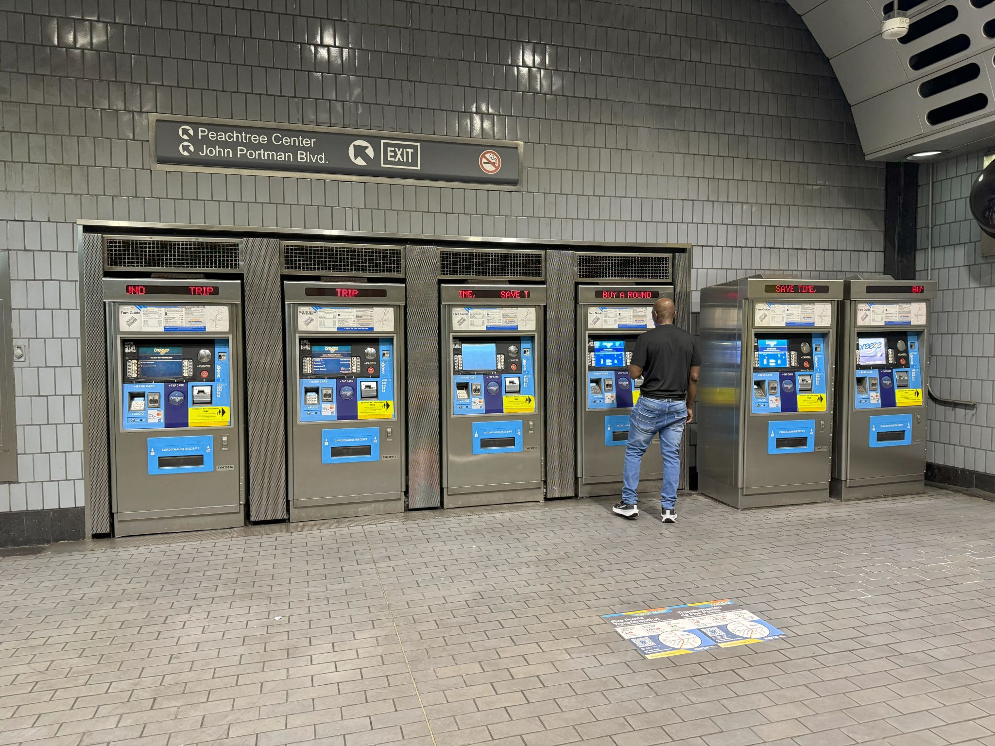 Guide to Exploring Atlanta on MARTA Trains (From a Local) 3 A man stands at a row of five modern, touchscreen ticket vending machines in a subway station in Atlanta, Georgia.