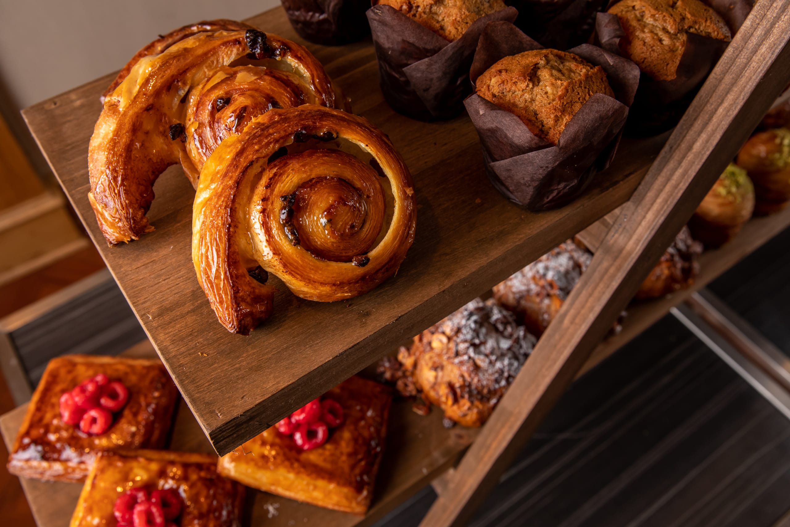 Top Pastry Chefs to Check Out in Atlanta 3 Assorted pastries and baked goods displayed on a wooden tiered stand in Atlanta, Georgia.