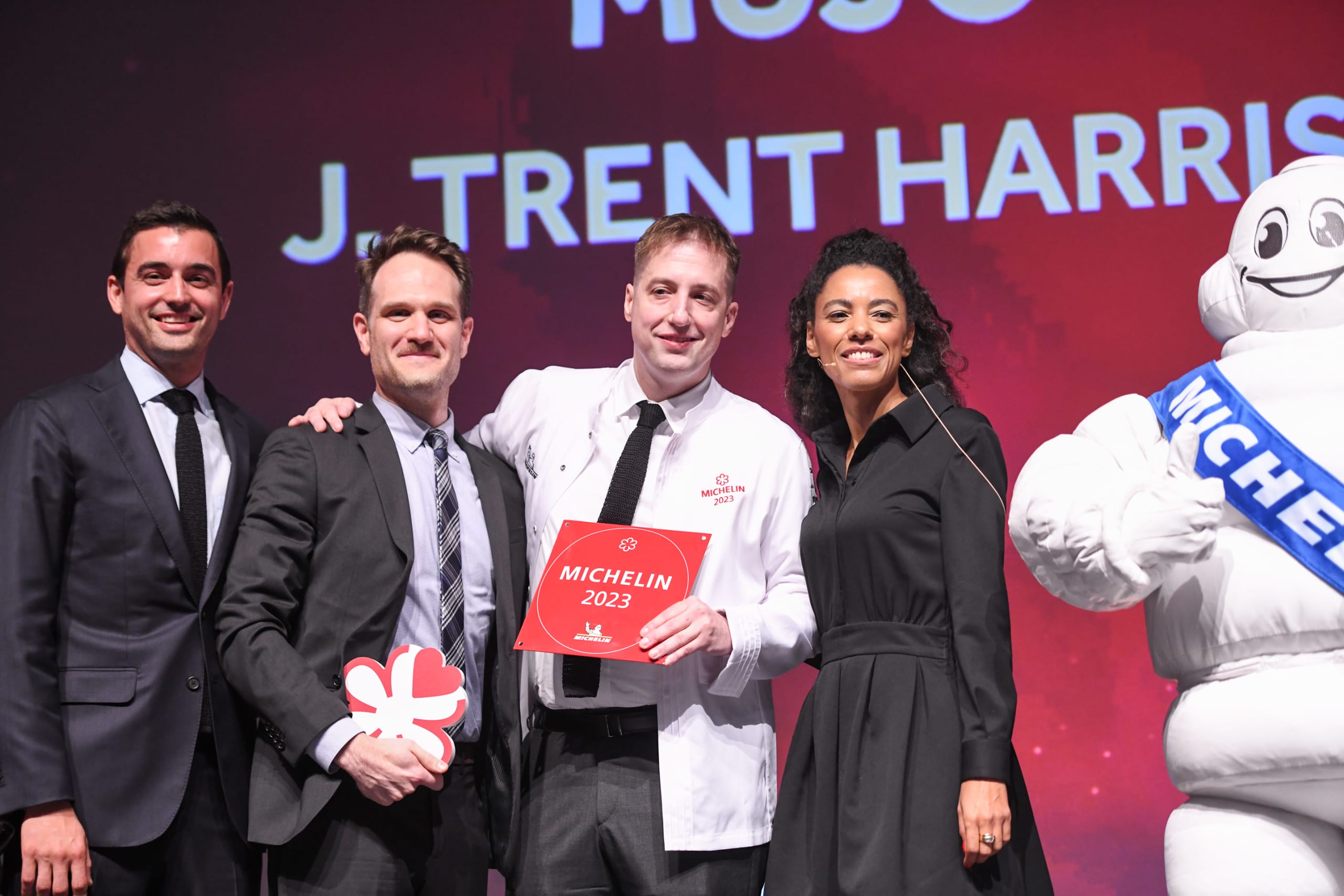 Another Year of the MICHELIN Guide in Atlanta 9 Four people stand on stage with Michelin Man, holding a Michelin 2023 award in Atlanta, Georgia.